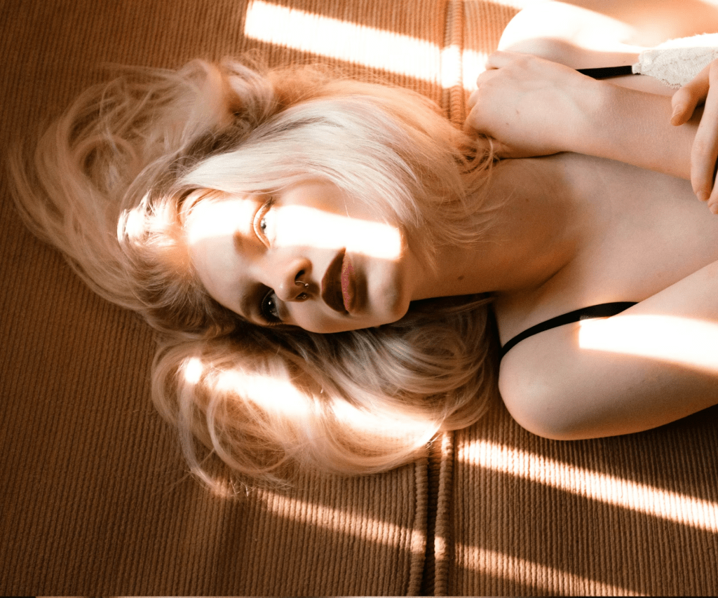 Woman lying in warm sunlight, Biird wellness brand case study