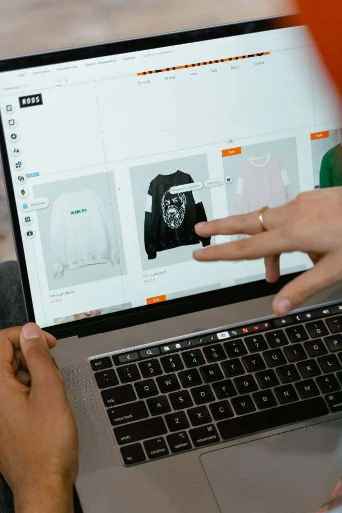 Hands browsing shopping website on laptop — Shopify Migration Experts